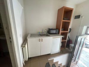 a small kitchen with a sink and a microwave at Turnul Portii in Sibiu