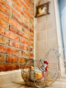 a cage with chickens in it next to a brick wall at Apartamentos Nel I in Santillana del Mar +55 photos