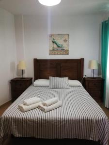 a bedroom with a large bed with two towels on it at Miguelangelo in Los Llanos de Aridane