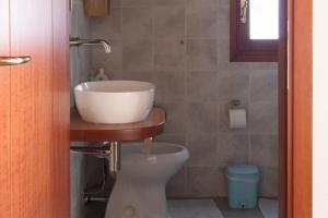 a bathroom with a sink and a toilet at Sa Guardia de Ferricci in Solanas