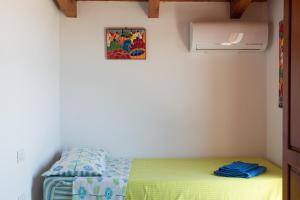 a bedroom with a bed and a picture on the wall at Sa Guardia de Ferricci in Solanas