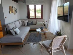 a living room with a couch and a table at Xenonas Apollon in Sarti