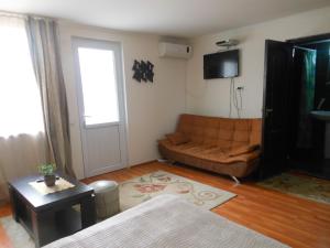 a living room with a couch and a television at Tamarindi Guest House in Mtskheta +21 photos