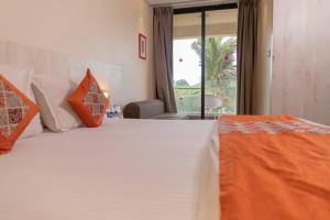 Postel nebo postele na pokoji v ubytování Hotel Citrus Prime Candolm, Goa