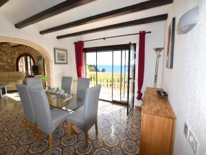 a dining room with a glass table and chairs at Casa Bonavista in Jávea