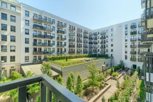 an apartment building with a courtyard with plants at Margi Soho Apartament in Szczecin