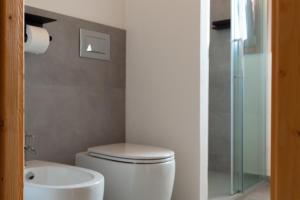 a bathroom with a toilet and a sink at Sa Guardia de Ferricci in Solanas