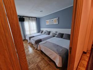 Postel nebo postele na pokoji v ubytování Hostal Fidalgo