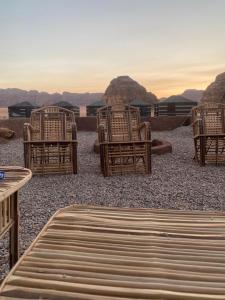 a group of chairs and tables in the desert at Adam Bedouin camp in Wadi Rum