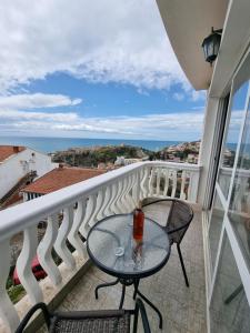 a table on a balcony with a view of the ocean at Apartments Adriatik in Ulcinj