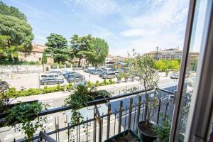 an apartment balcony with a view of a parking lot at B&B Happiness - City Center in Verona