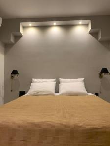 a bedroom with a large bed with white pillows at Varkiza Lux Apartment in Varkiza
