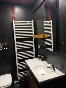 a bathroom with a sink and a mirror at Varkiza Lux Apartment in Varkiza +13 photos