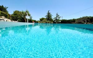 a large swimming pool with blue water at Villa Rina in Avola