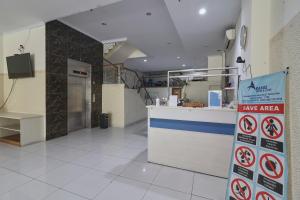 a restaurant with a counter with signs on it at Aranis Hotel in Jakarta