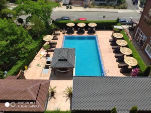 an overhead view of a pool with chairs and umbrellas at Dolce Vita Residenza in Nesebar