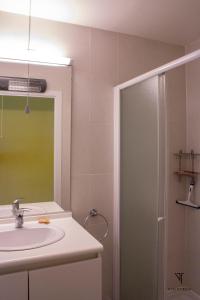 La salle de bains est pourvue d'un lavabo et d'une douche avec un miroir. dans l'établissement L'arc en ciel, à Bray-Dunes