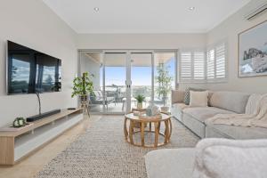a living room with a couch and a table at The Haven on Blue Bay in Mandurah
