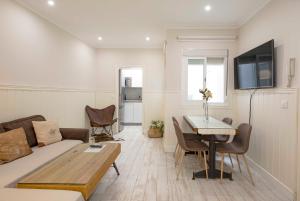 een woonkamer met een bank en een tafel bij Apartamentos Recaredo 7 , 2ª planta in Sevilla
