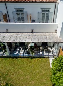 an external view of a house with a wooden deck at Poseidonion Grand Hotel in Spetses