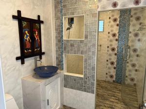 a bathroom with a blue sink and a shower at The One Sabai Living Pattaya in Pattaya