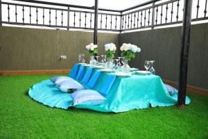 a table with a blue table cloth and flowers on it at Galaxy Motel Kampala in Kampala