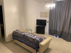 a living room with a couch and a television at Residence La Settima in Milano Marittima