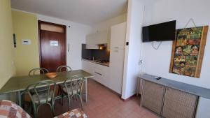 a kitchen and dining room with a table and chairs at Ca'Costanza in Bibione