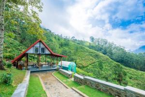 a pavilion with a mountain in the background at Floating Mountain Villa in Nuwara Eliya
