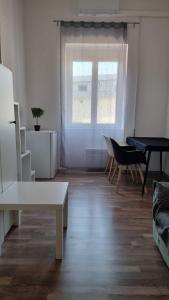 a living room with a table and a window at PARIS in Ljubljana