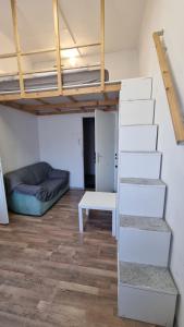 a room with a loft bed and a couch at PARIS in Ljubljana