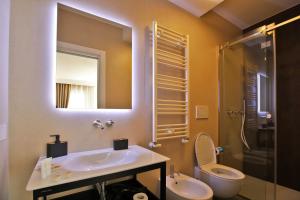 a bathroom with a sink and a toilet and a mirror at MEDITERRANEO RELAX in Polignano a Mare