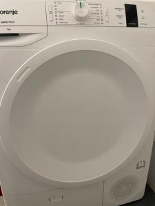 a white washing machine with its door open at PARIS in Ljubljana