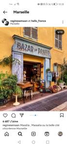 a shop with a table in front of a building at Massilia Calling love Appartement de standing 8 personnes Marseille proche métro parking facile in Marseille