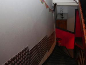 a staircase in a room with a red and white wall at H&ocirc;tel Latino Reims Centre in Reims