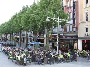 ランスにあるHôtel Latino Reims Centreの屋外レストランの椅子に座る人々 +2枚の写真