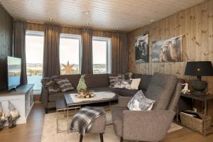 a living room with a couch and a table at Bualie - Golsfjellet - Biking, swimmming, hiking. High standard. in Gol