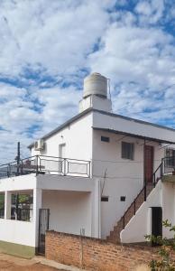 a white building with a lighthouse on top of it at Departamento monoambiente vacacional in Posadas