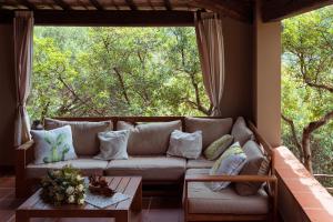 a living room with a couch and a large window at Sa Guardia de Ferricci in Solanas