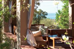 a room with a couch and a table on a balcony at Sa Guardia de Ferricci in Solanas