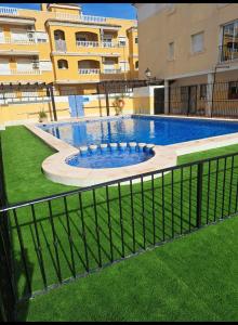 a large swimming pool in front of a building at BRISAS DEL MAR II in Formentera del Segura