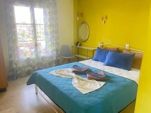 a bedroom with a bed with two towels on it at Villa Corfiota Moraitika Beach in Moraitika