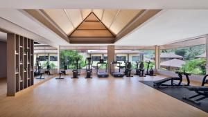 a gym with treadmills and exercise equipment in a building at Mulberry Shades Bengaluru Nandi Hills - a Tribute Portfolio Resort in Bangalore