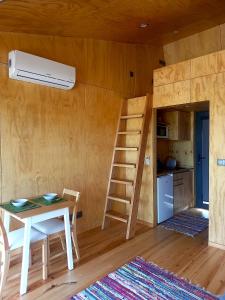 a room with a table and a ladder and a kitchen at Refugio do Carrascal in Tomar +30 photos