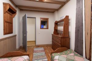 a bedroom with a bed and a dresser and a closet at Hostel Pomor in Barentsburg