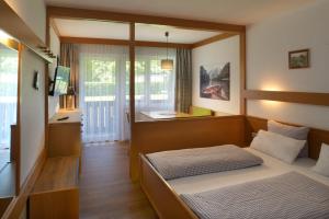 sypialnia z łóżkiem i biurkiem w obiekcie Appartement-Hotel Happy Kienberg w mieście Pfronten