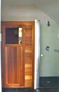 a wooden door in the corner of a room at Landhuis het Woud. max. 11 pers. with private pool in Bergen