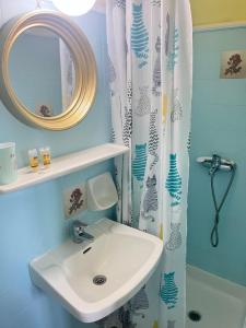 a bathroom with a sink and a mirror at Villa Corfiota Moraitika Beach in Moraitika