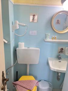 a blue bathroom with a sink and a toilet at Villa Corfiota Moraitika Beach in Moraitika