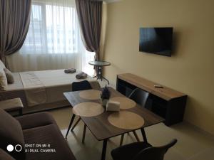 a small room with a bed and a table and chairs at Dolce Vita Residenza in Nesebar